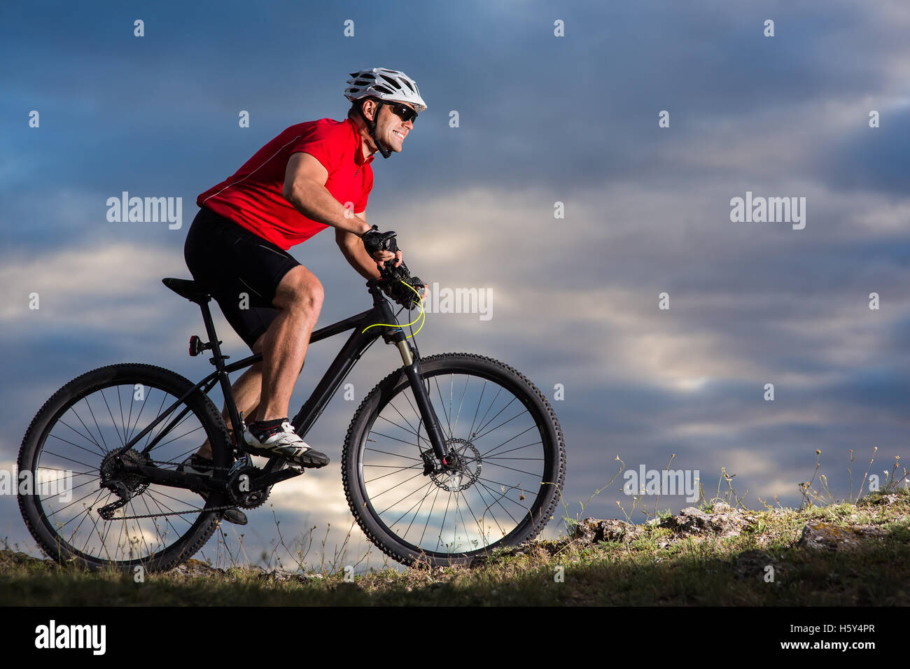 Single Track Riding Mountain Bike cyclist riding single track outdoor with blue sky on ...