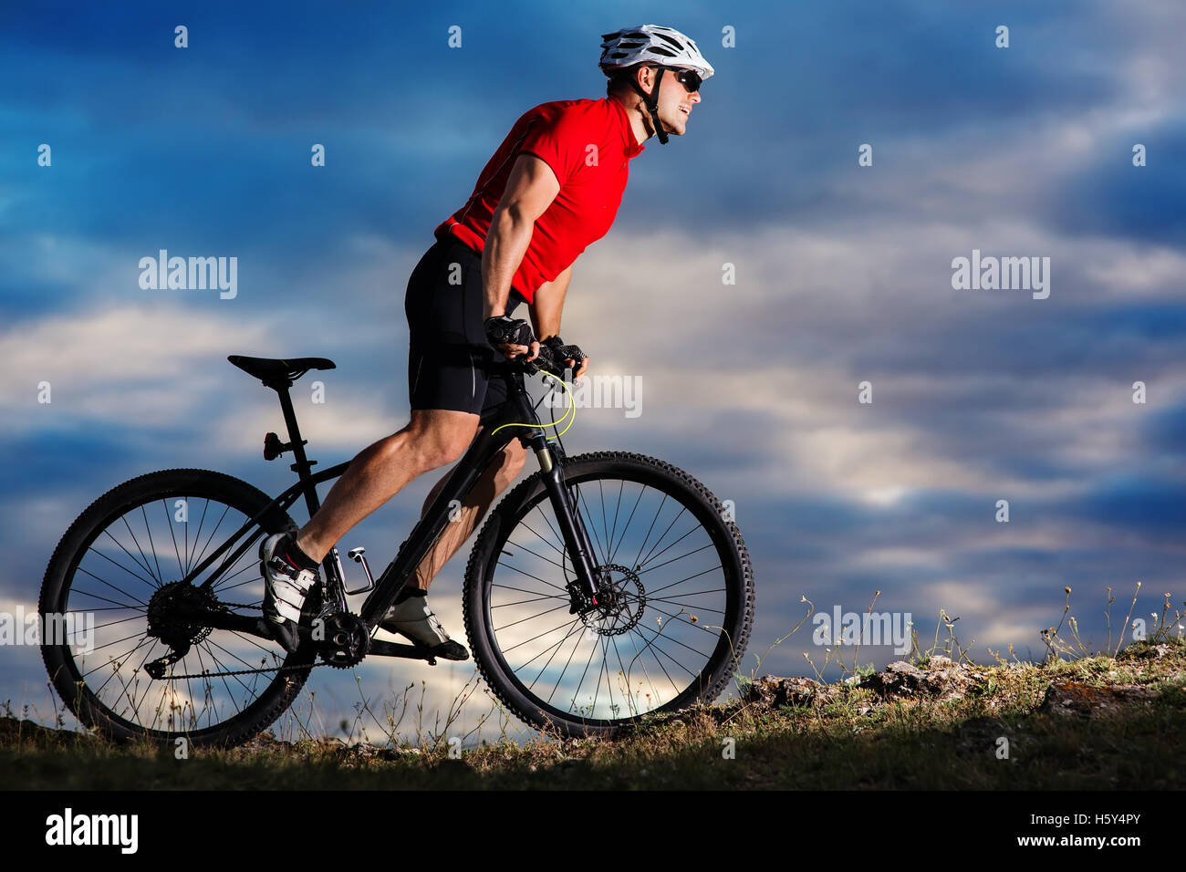 Mountain Bike cyclist riding single track outdoor with blue sky on ...