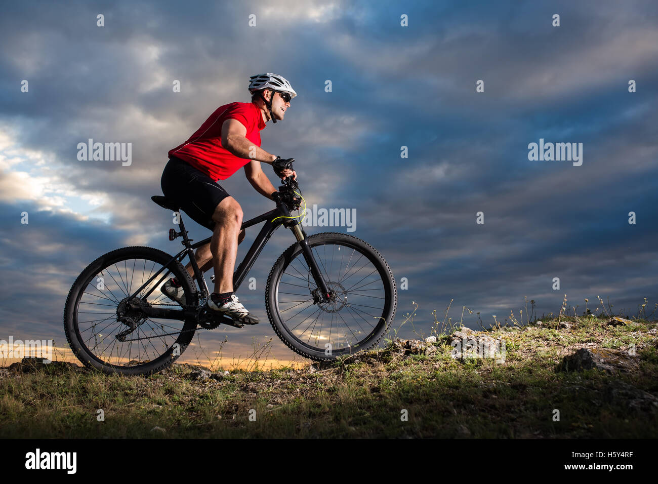 Mountain Bike cyclist riding single track outdoor with blue sky on ...
