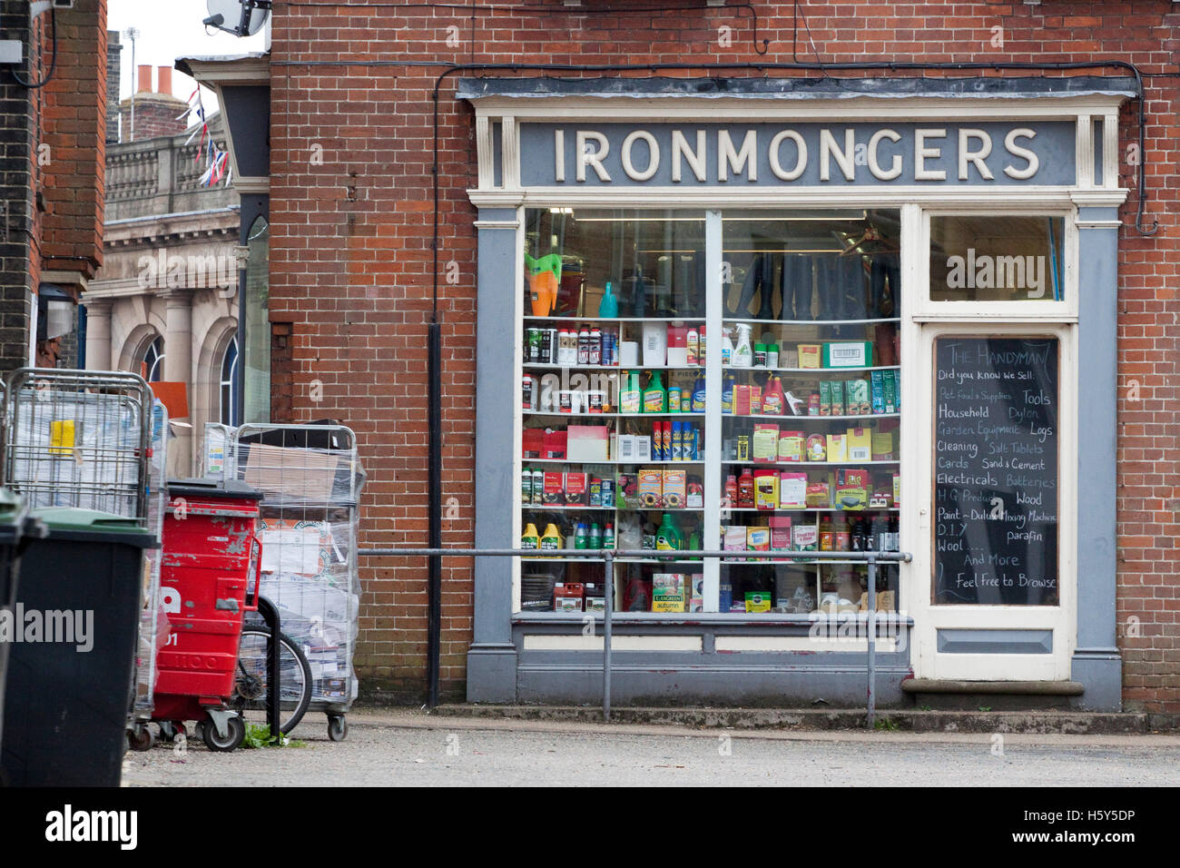 A traditional ironmongers shop with crowded shop window Stock Photo