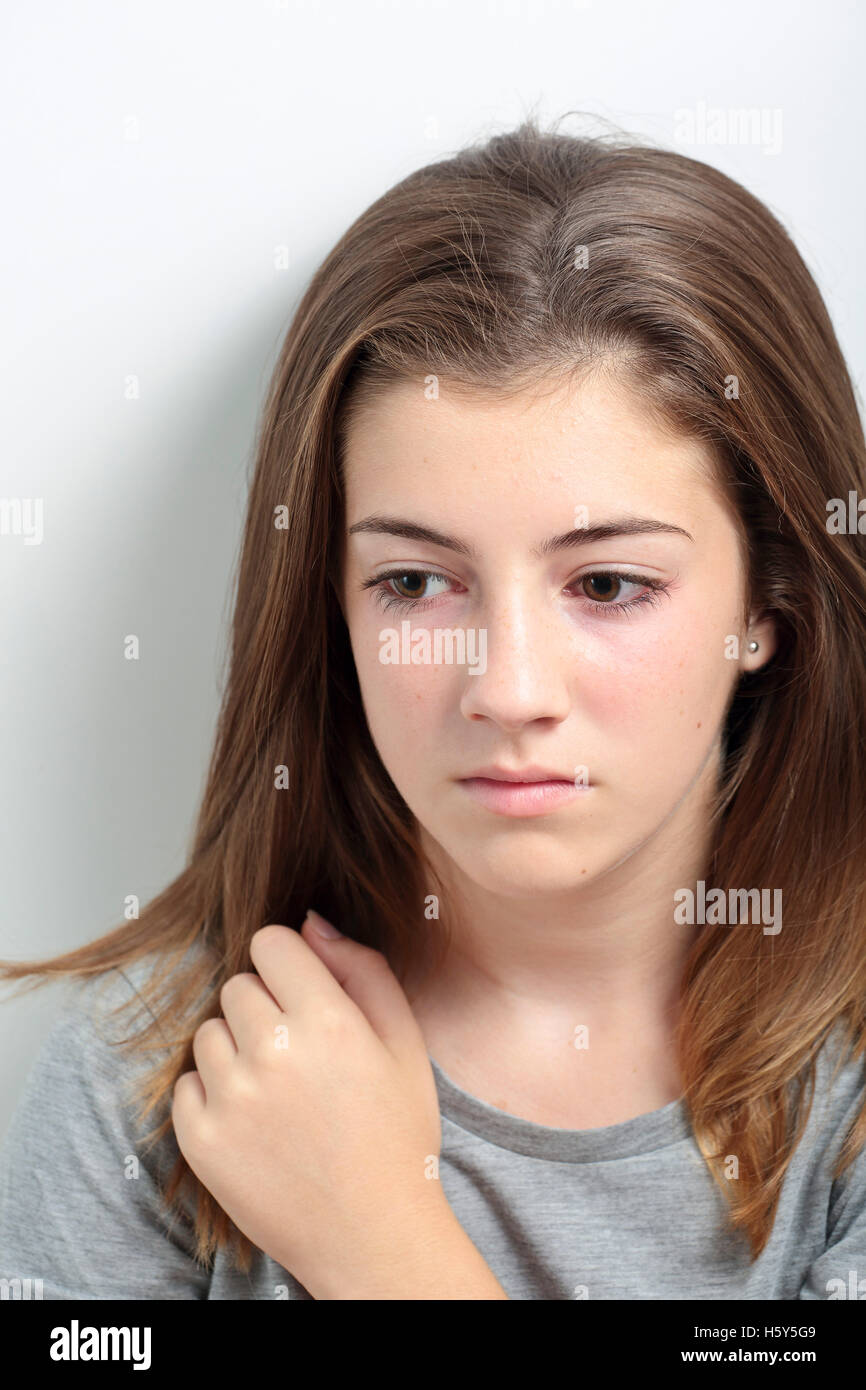 Portrait of a teenager with a serious face. Capture vertical light of study. Stock Photo