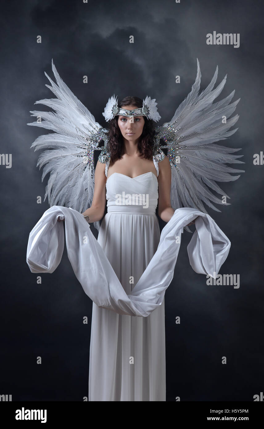 Young beautiful woman in white dress with angel wings Stock Photo - Alamy