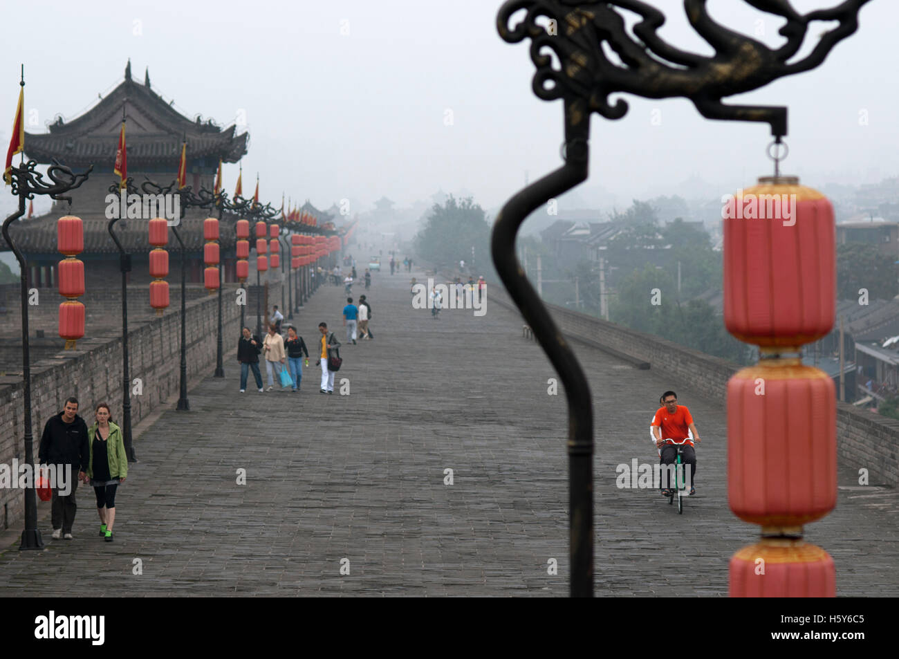 Tourists and local people walking around the ancient Xian City Great Wall, Shaanxi, China Stock Photo