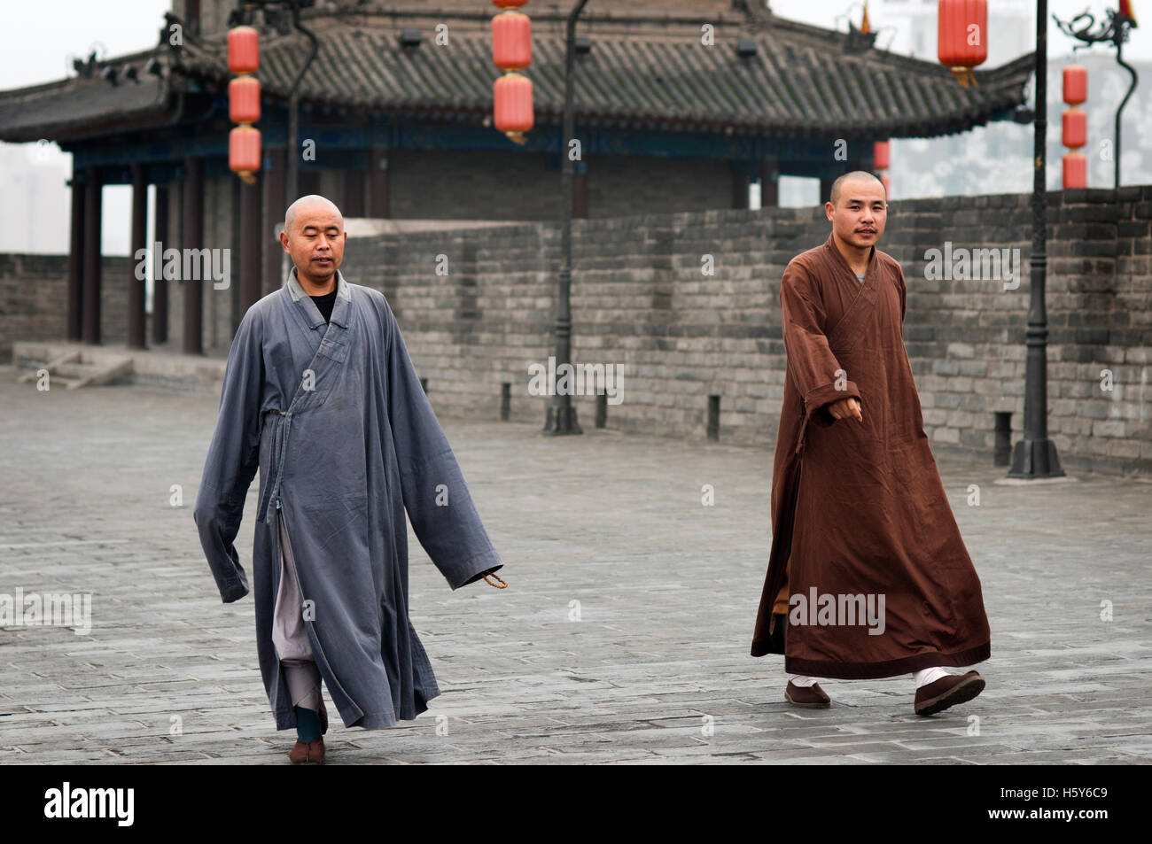 Monks walking in the ancient Xian City Wall Gate and Tower, Shaanxi, China Stock Photo