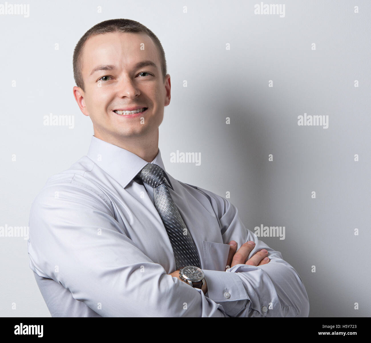 young businessman in grey shirt with tie Stock Photo