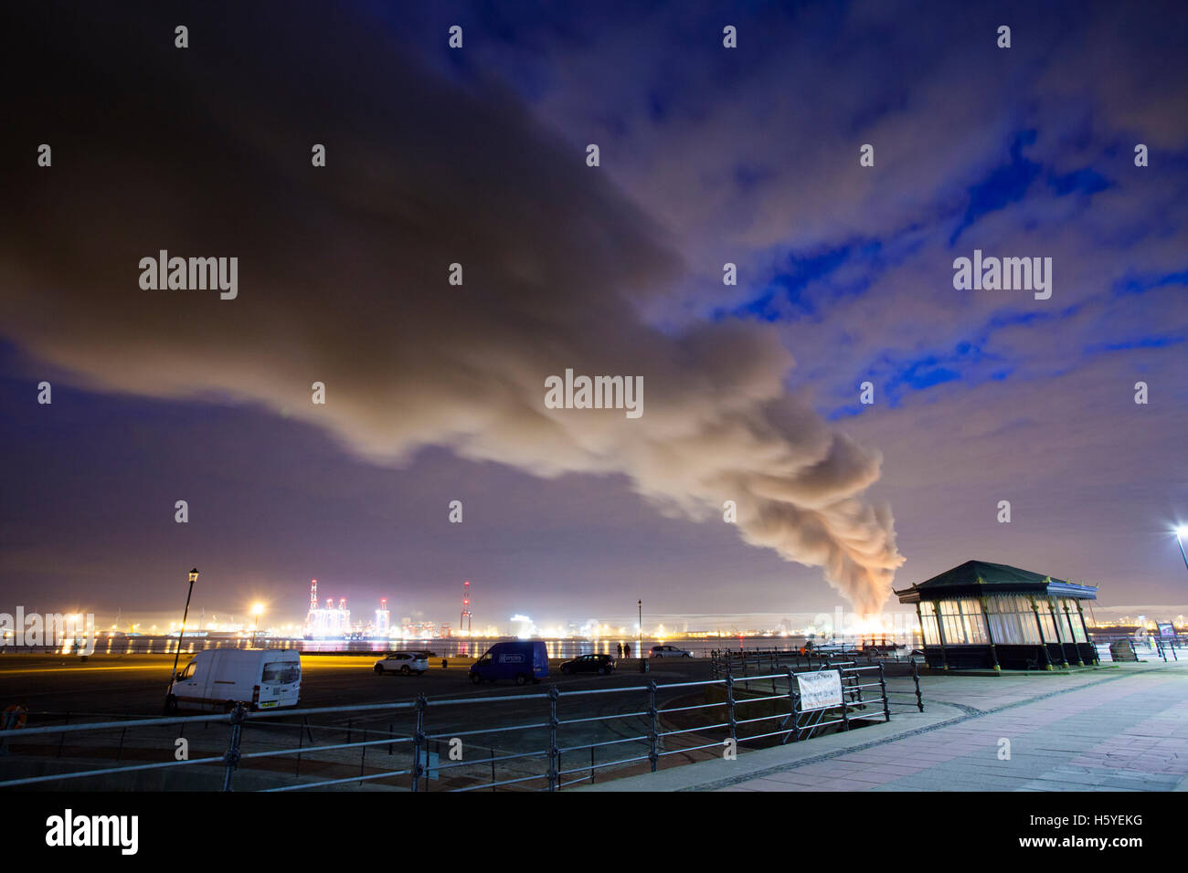 Large fire at Liverpool docks with the smoke plume passing over New Brighton and on towards North Wales early morning Stock Photo