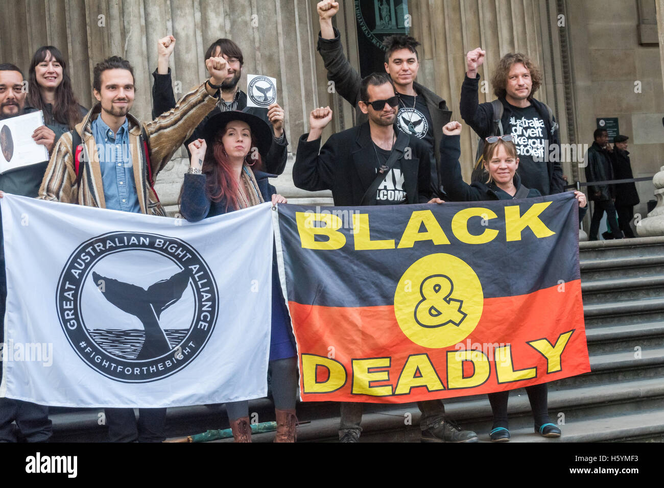 London, UK. 22 October 2016. Supporters of Aborigine rights, including Bunna Lawrie, an indigenous Australian Mirning elder, musician and a leading figure in the fight which led to BP recently halting plans for offshore oil drilling in the Great Australian Bight pose with banners on the steps of the BP sponsored British Museum with other campaigners including fellow Australian aborigines here to discuss the return of tribal artefacts held by the museum. Credit:  Peter Marshall/Alamy Live News Stock Photo