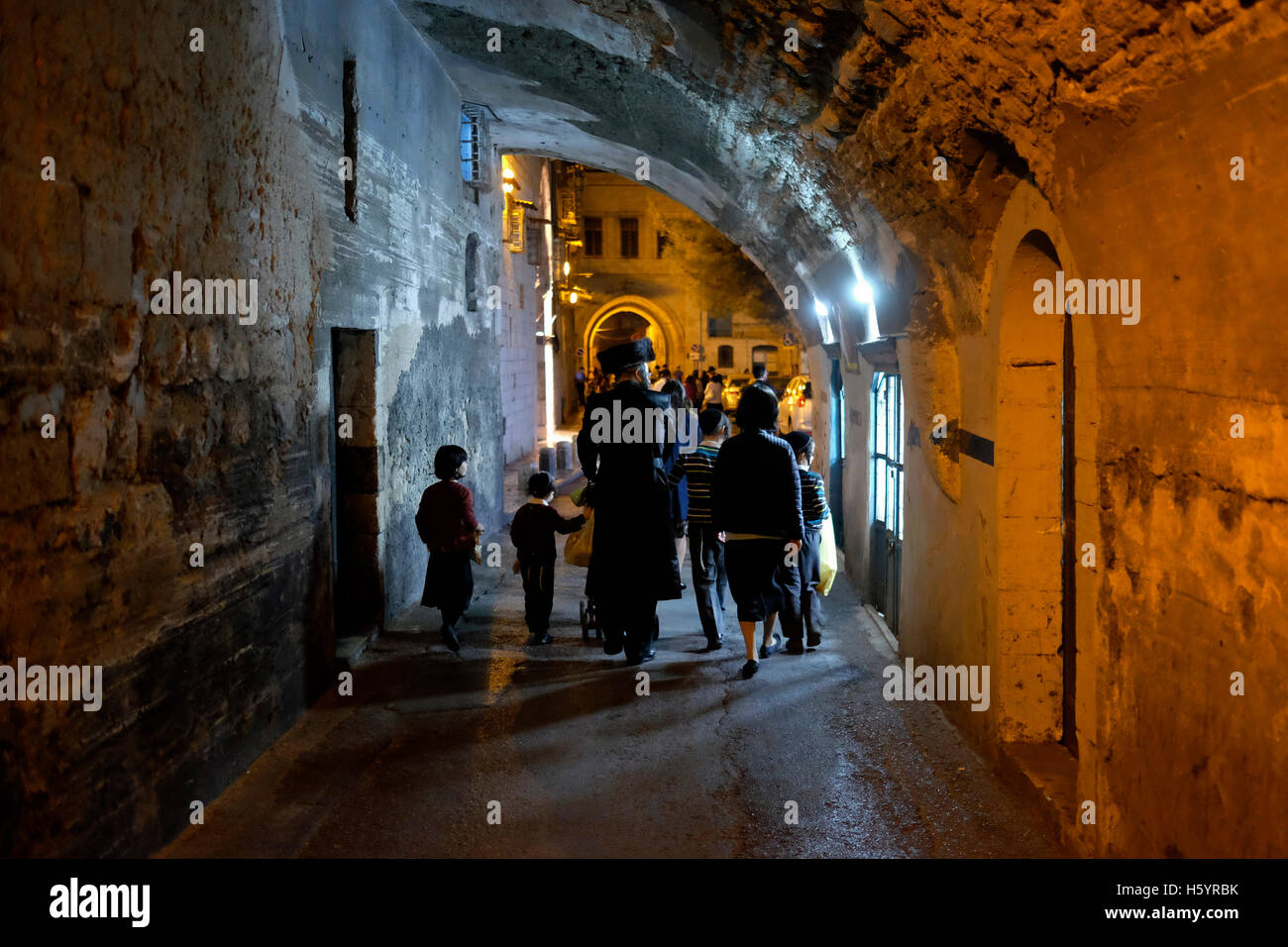 Ultra Orthodox Jews walking along the Armenian Patriarchate street in the Armenian quarter in the old city of East Jerusalem Israel Stock Photo