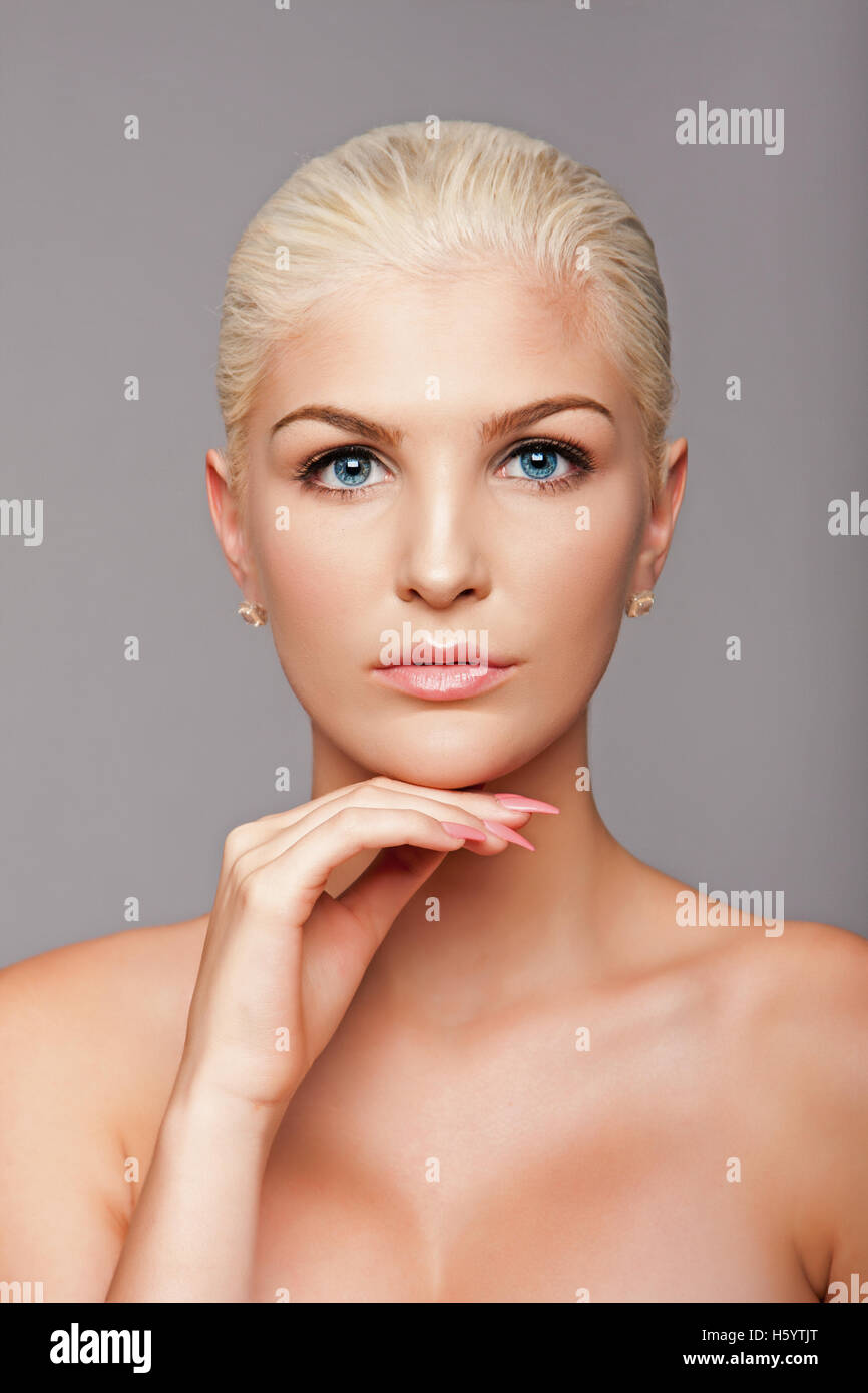 Beauty portrait face of beautiful blond woman with blue eyes and smooth skin, aesthetics skincare concept. Stock Photo