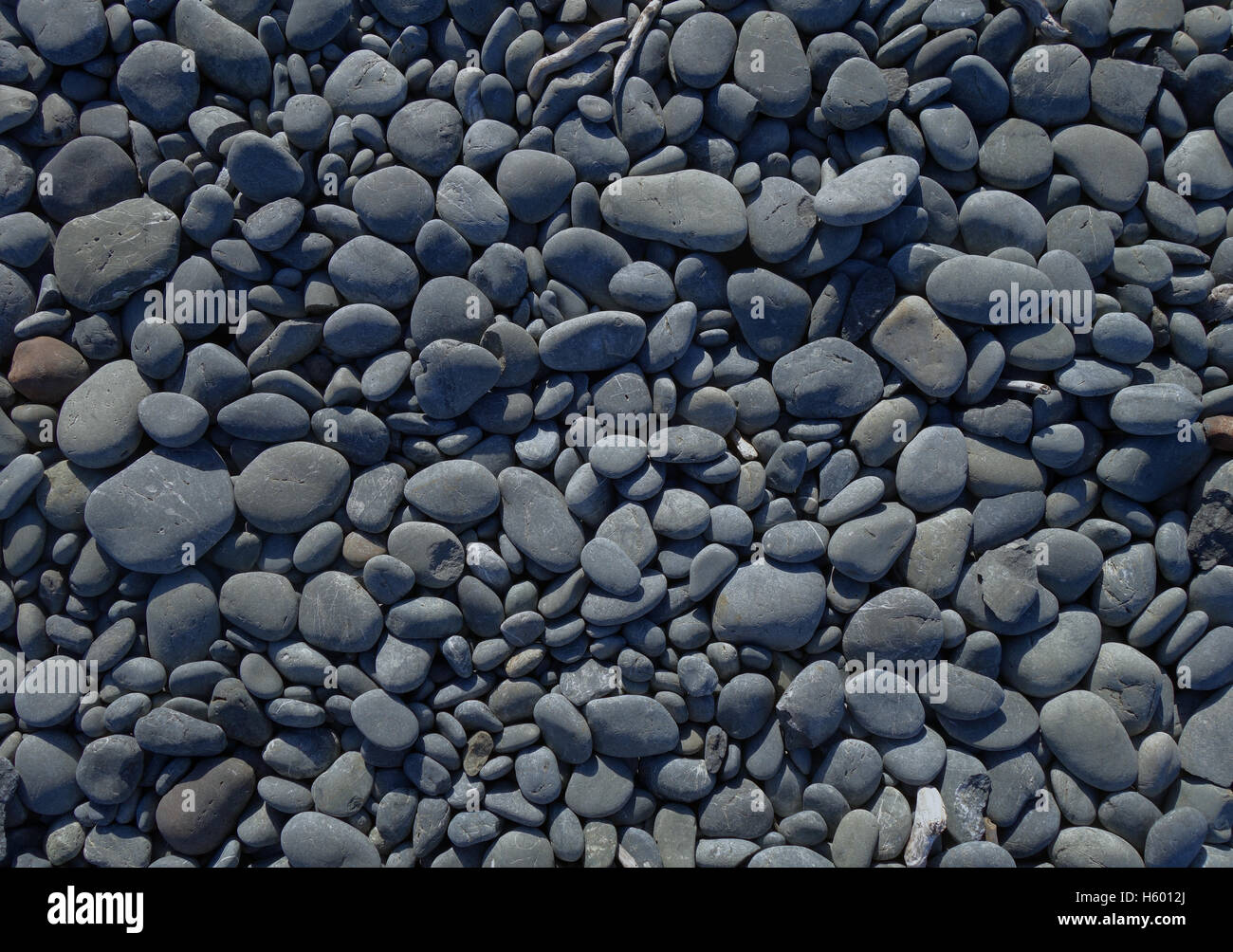 pebbles on a beach background texture wallpaper Stock Photo