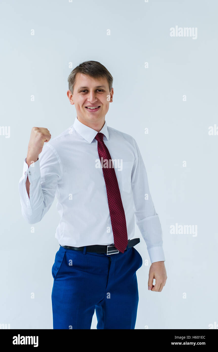 A men in a white shirt boxing smiling and shows his straight Stock Photo