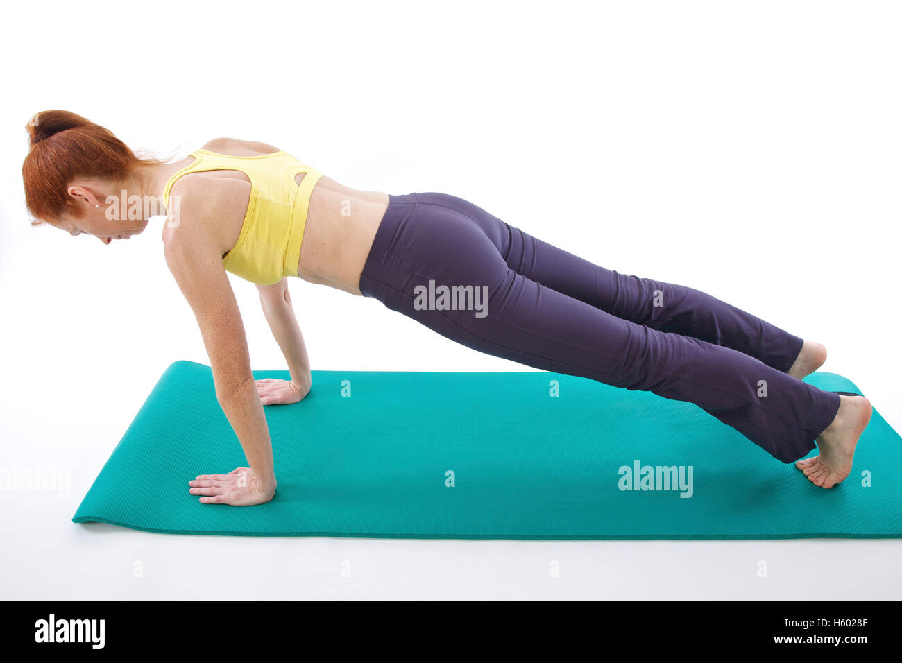 Woman exercising on a gymnastics mat Stock Photo