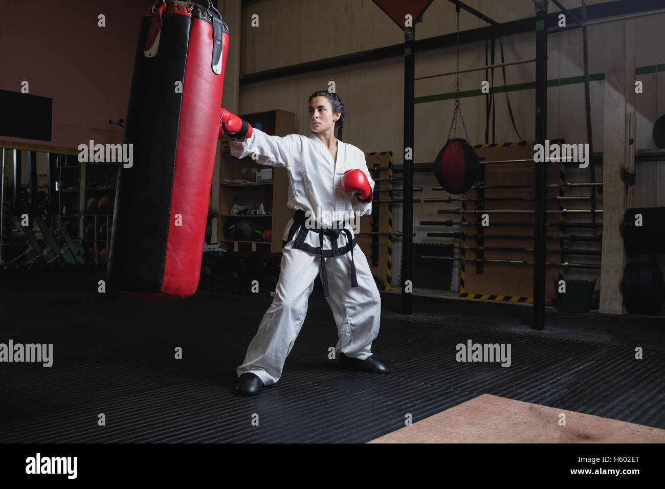 Woman practicing karate with punching bag Stock Photo Alamy