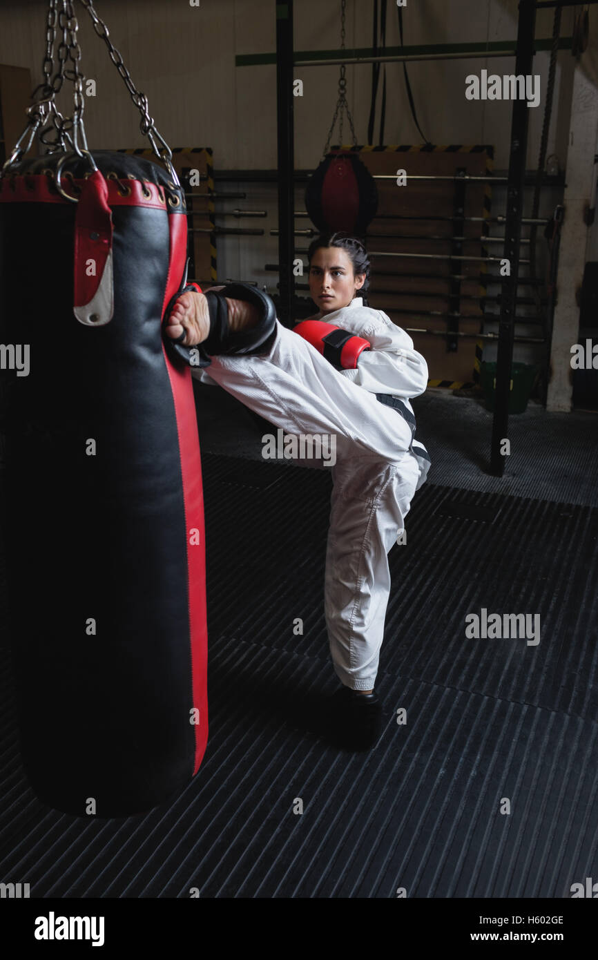 Woman practicing karate with punching bag Stock Photo Alamy
