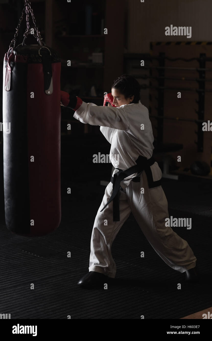 Woman practicing karate with punching bag Stock Photo Alamy