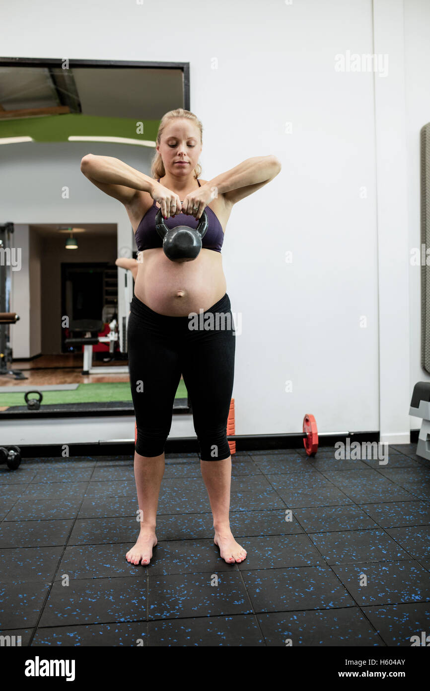 Pregnant woman lifting kettlebell Stock Photo Alamy