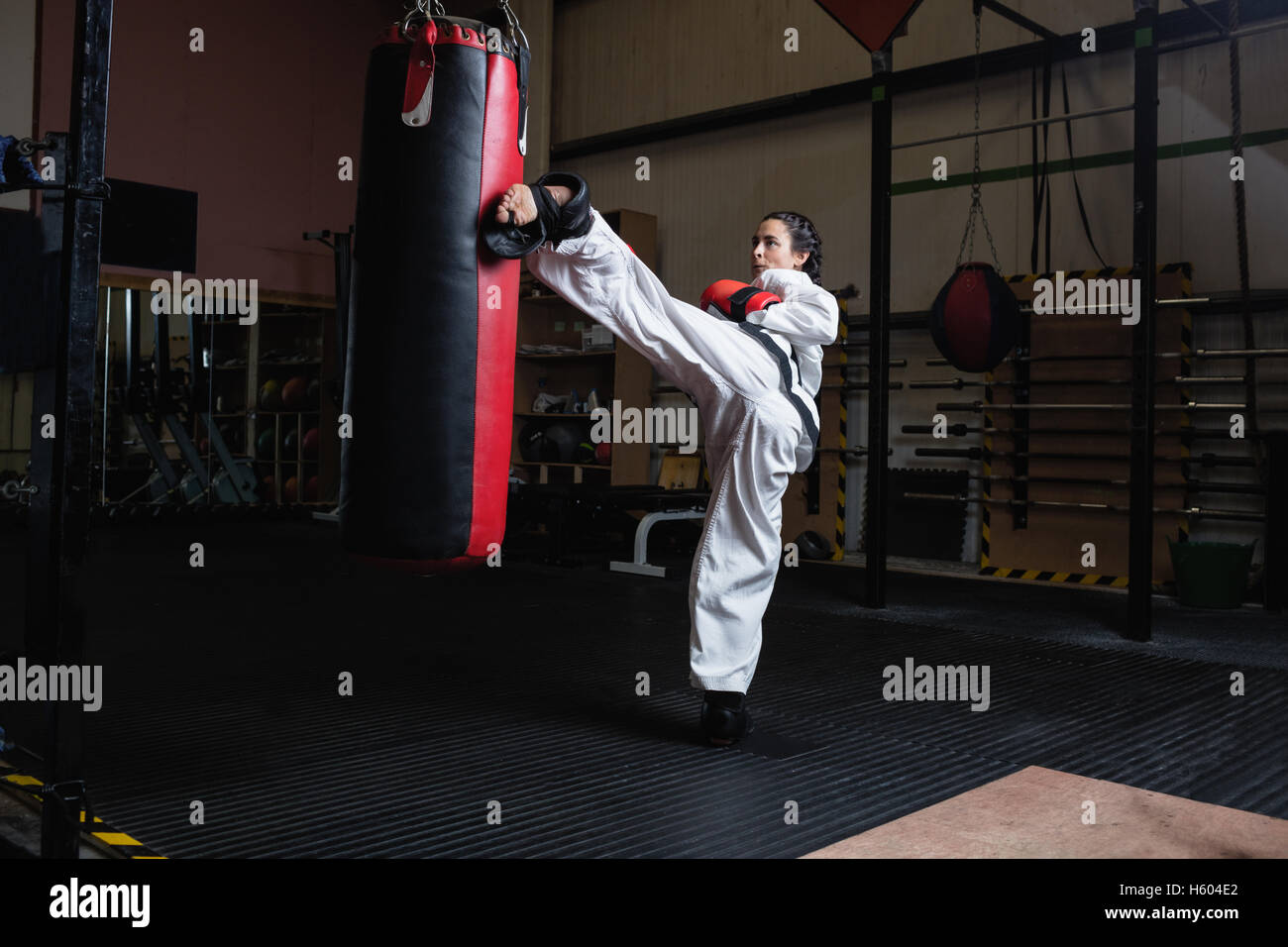 Woman practicing karate with punching bag Stock Photo Alamy