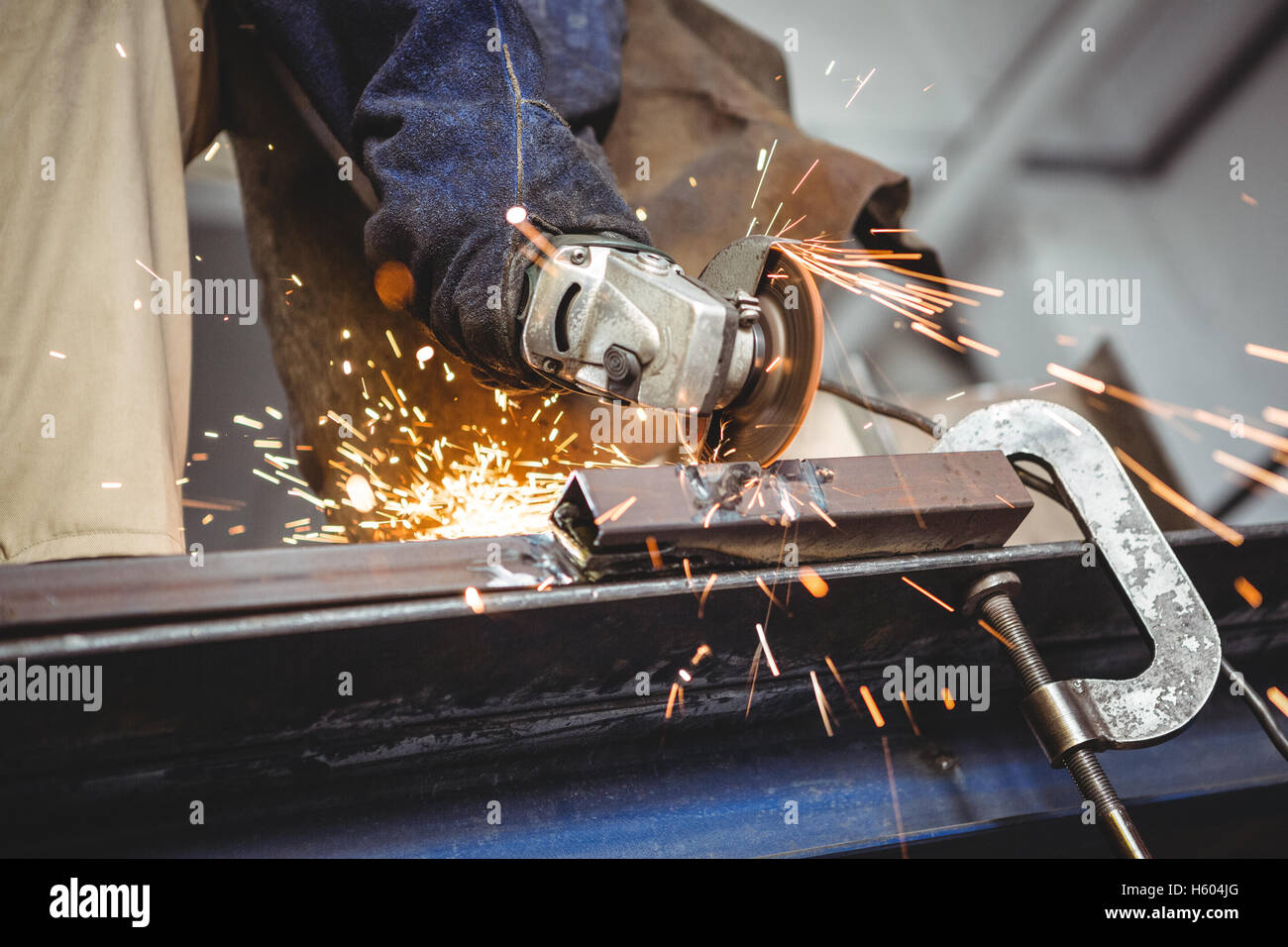 Welder cutting metal with electric tool in Stock Photo Alamy