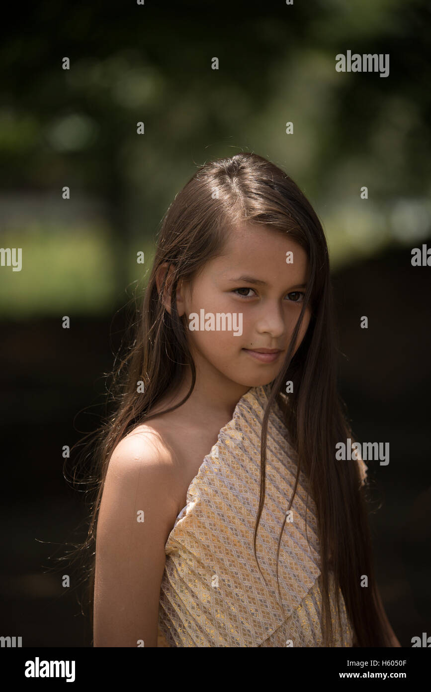 Portrait of mixedrace beautiful long hair girl wear Thai local dress