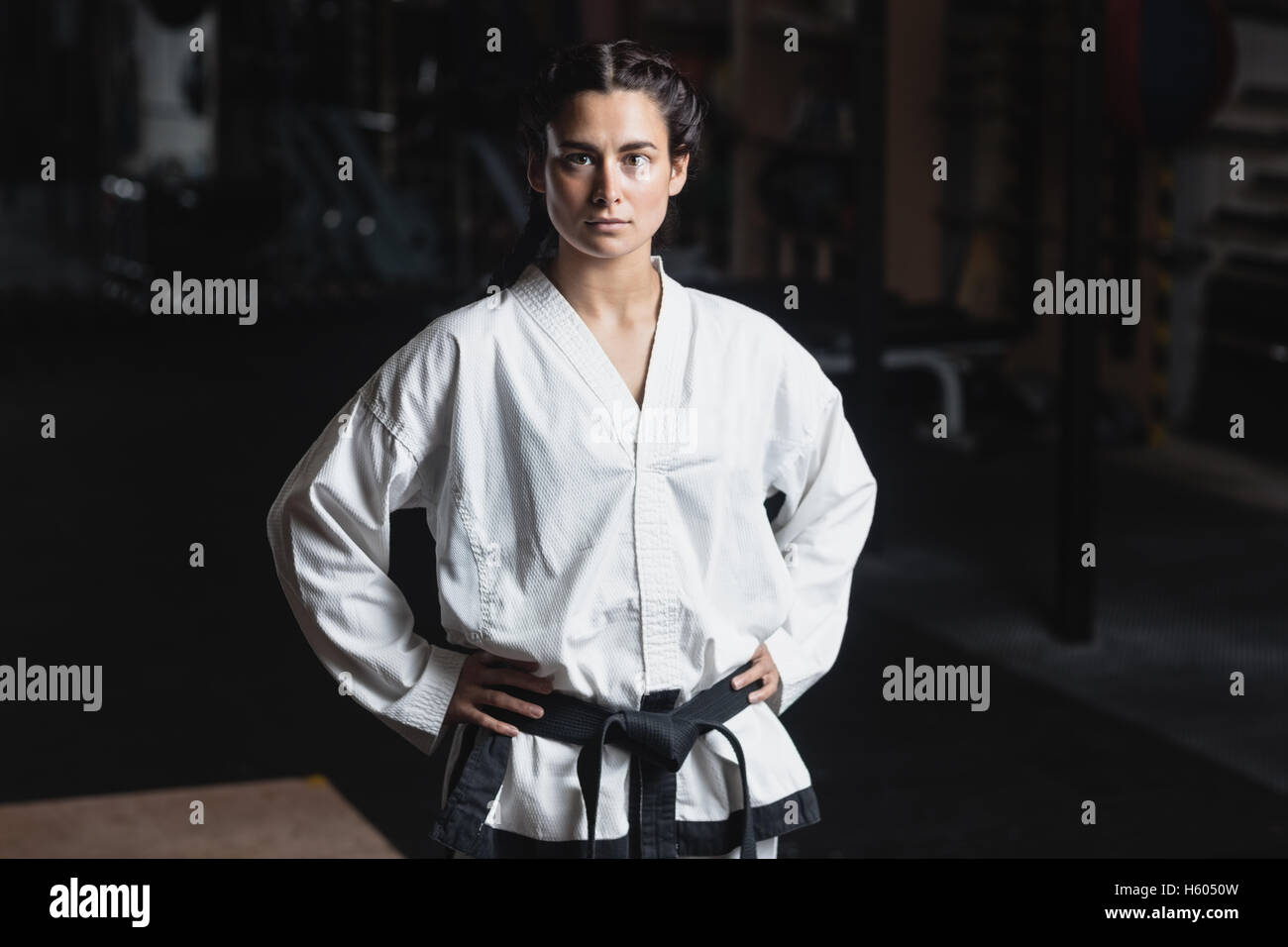 Portrait of karate woman standing with hand on hip Stock Photo