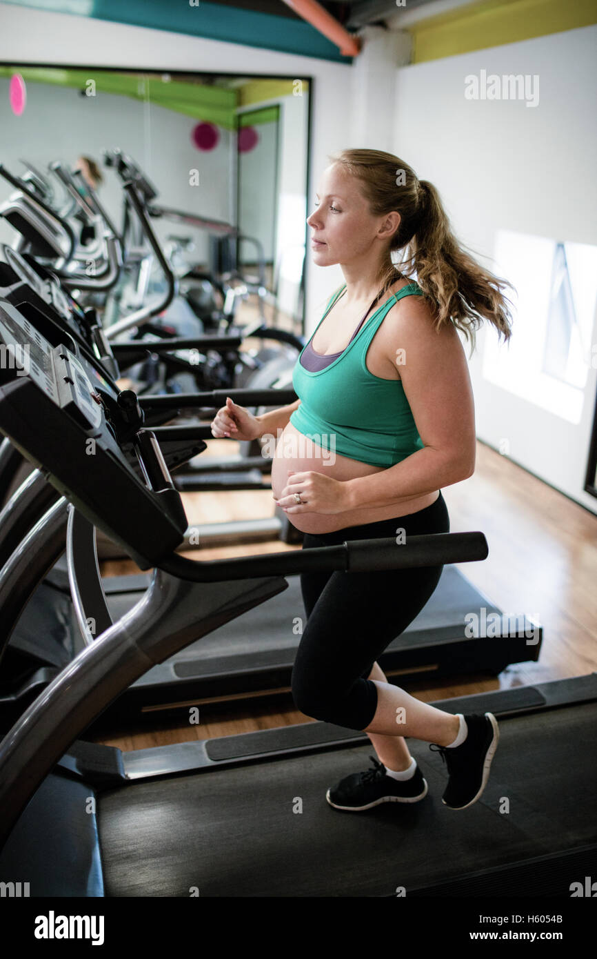Pregnant woman exercising on treadmill Stock Photo Alamy