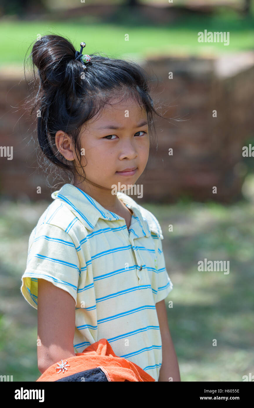 little Asian girl look at right side while she in outdoor park Stock
