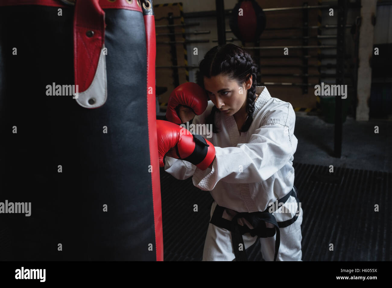 Woman practicing karate with punching bag Stock Photo Alamy