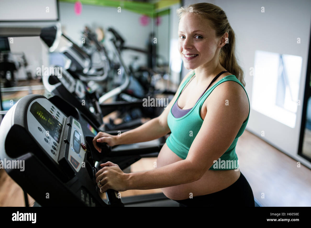 Pregnant woman exercising on treadmill Stock Photo Alamy