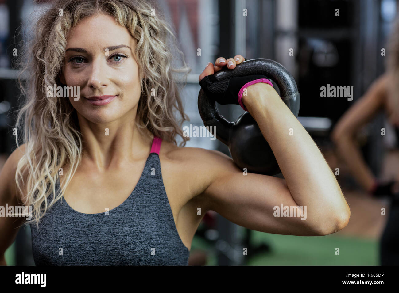 Beautiful woman lifting kettlebell Stock Photo