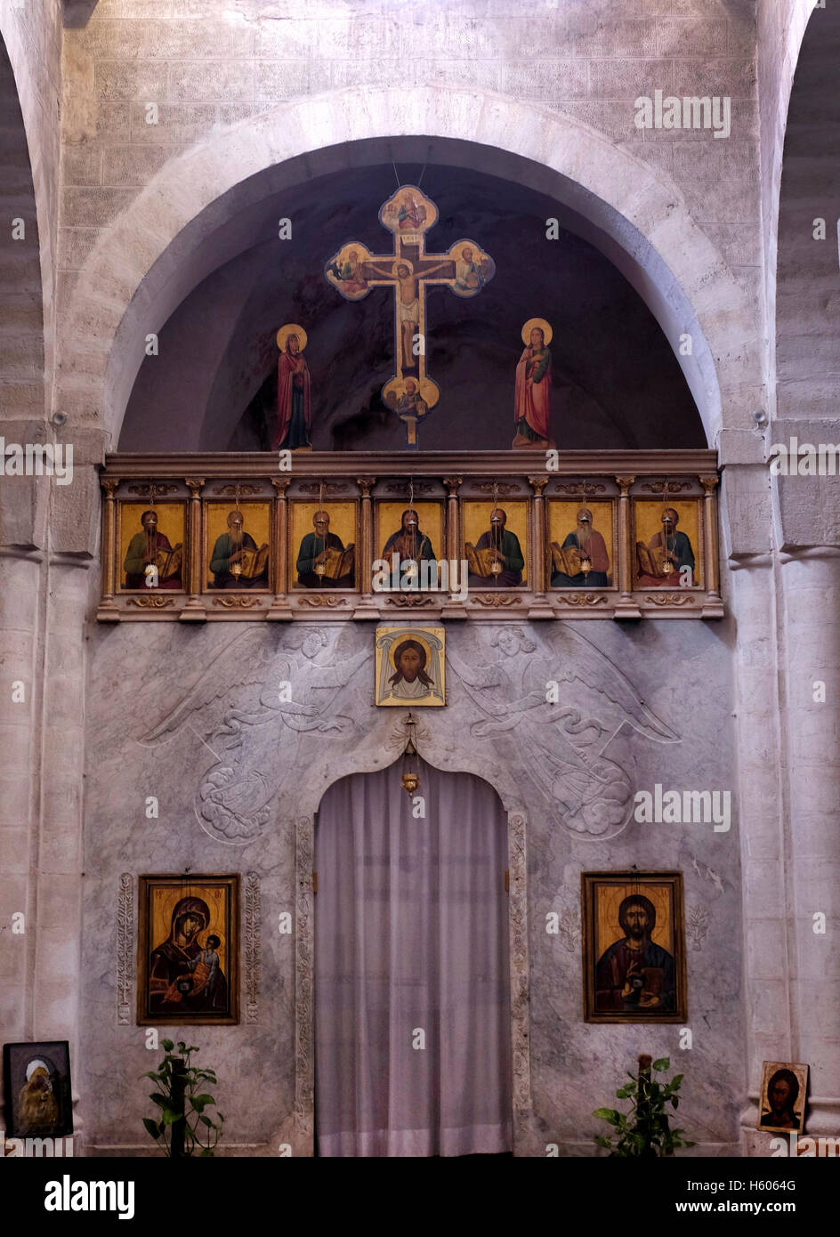 Crucifix of Jesus on the cross and other religious icons inside the Greek Catholic (Melkite) Church of Saint or Santa Veronica in Via Dolorosa old city East Jerusalem Israel Stock Photo