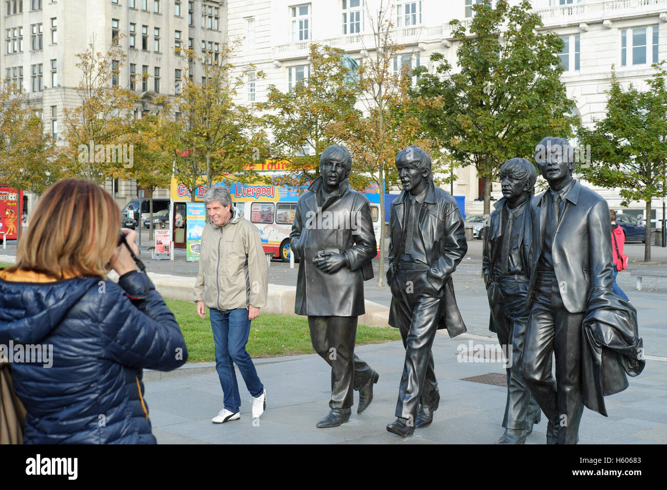 Tourists take pictures of the bronze Beatles statue in Liverpool Stock Photo