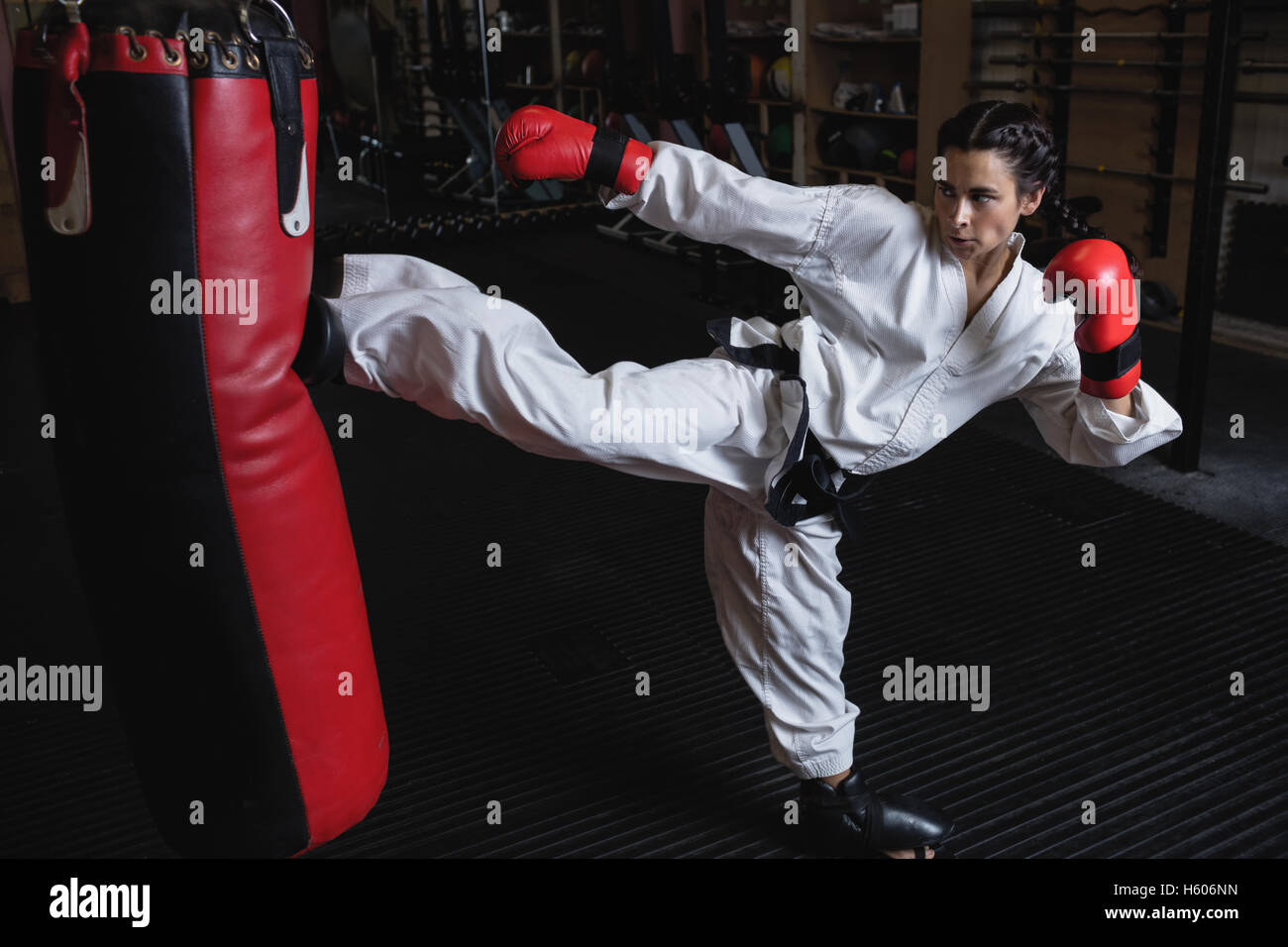 Woman practicing karate with punching bag Stock Photo Alamy