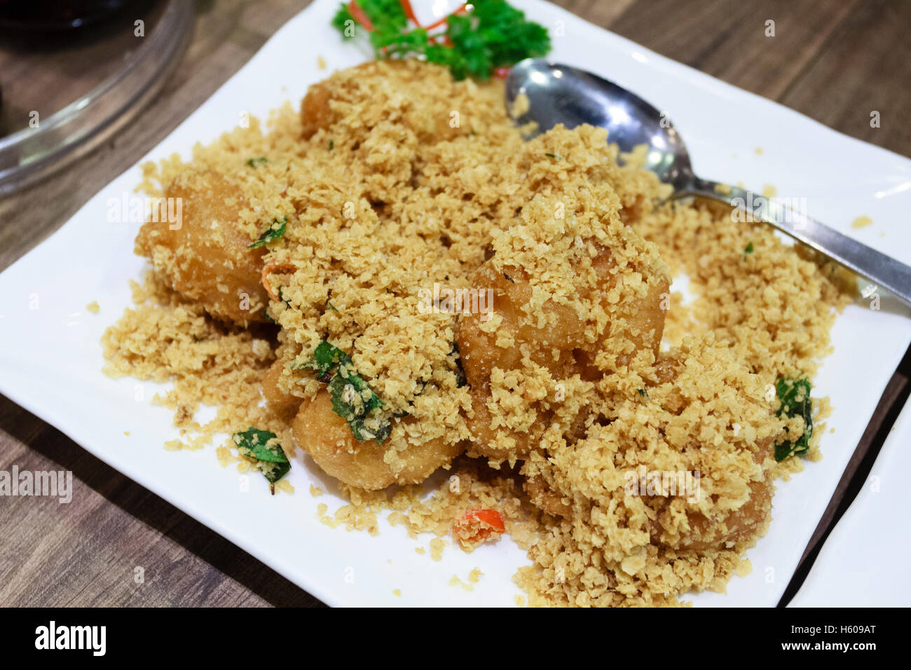Chinese food dish of cereal prawns in a restaurant in Singapore Stock Photo