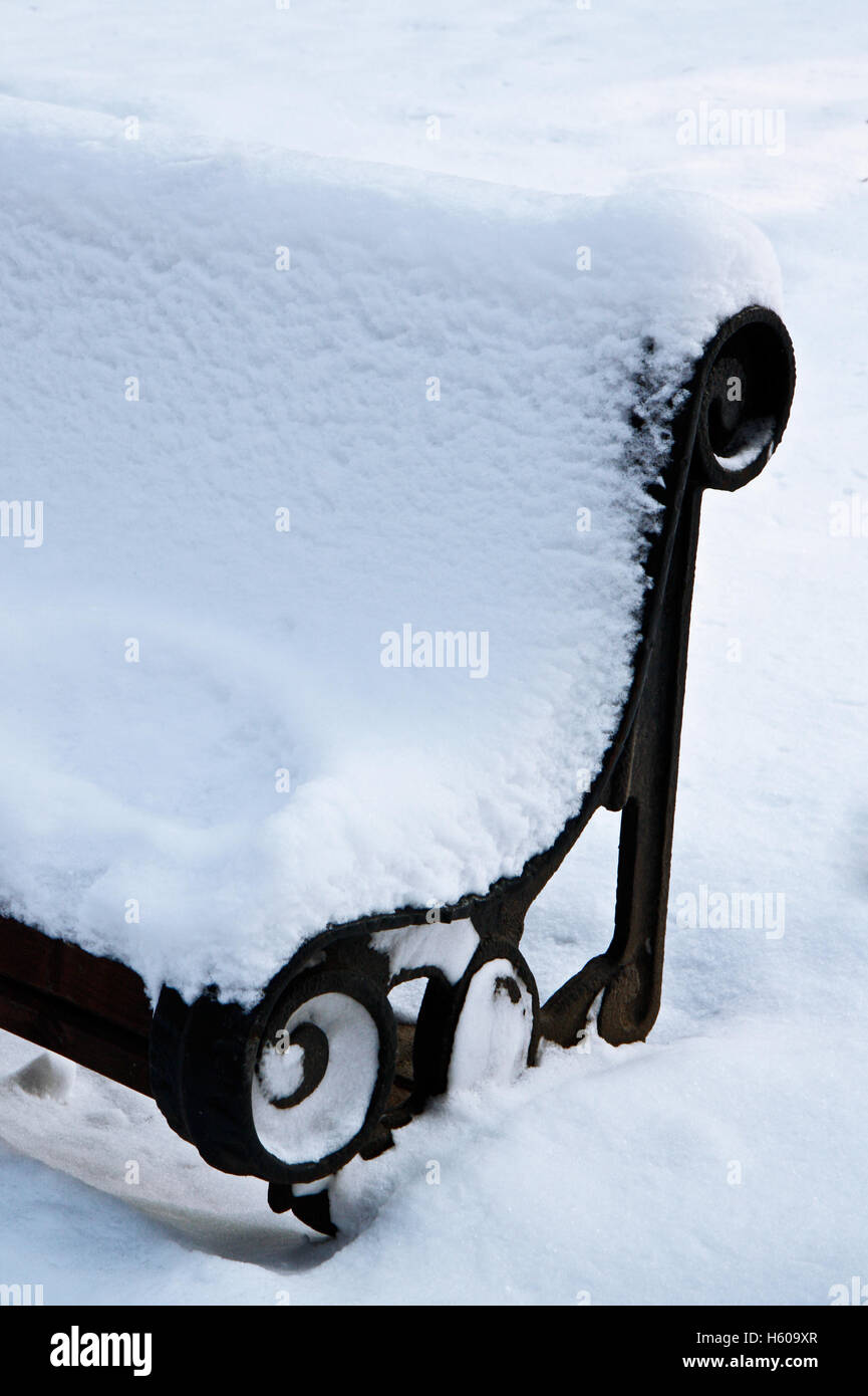 Snow covered garden benches in winter park Stock Photo