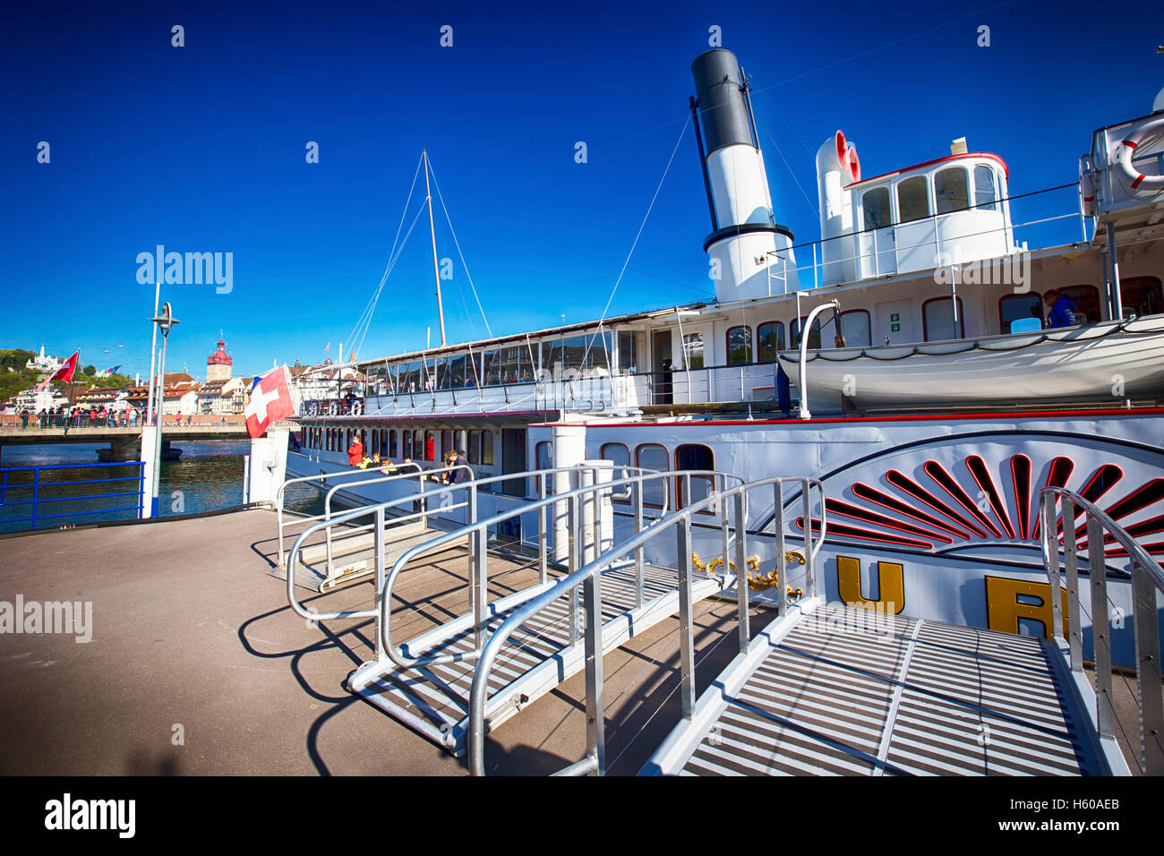 Steam boat on lake Lucerne (Vierwaldstatersee) in harbor with the historic old city Lucerne in the background, Switzerland Stock Photo