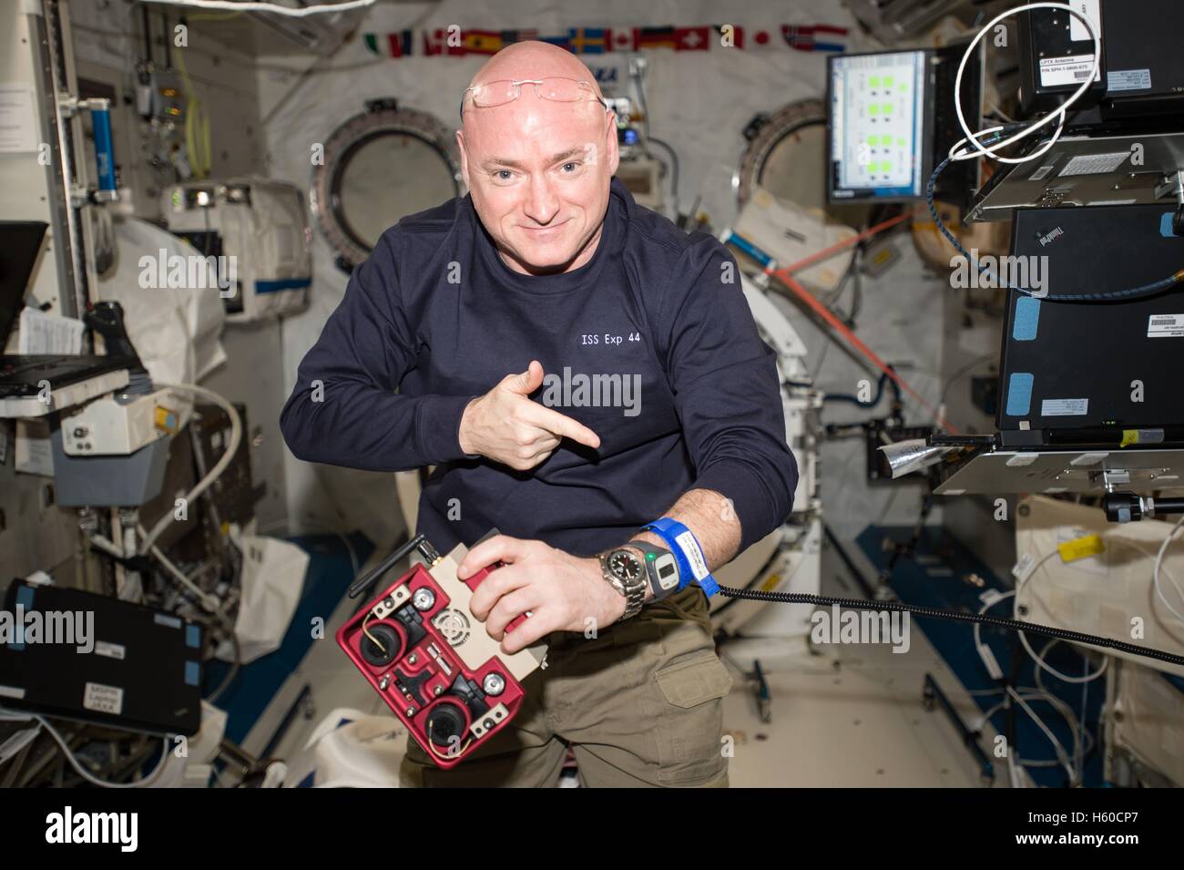 NASA International Space Station Expedition 44 mission prime crew astronaut Scott Kelly operates a SPHERES satellite used for spacecraft docking and maneuvers September 10, 2015 while in Earth orbit. Stock Photo