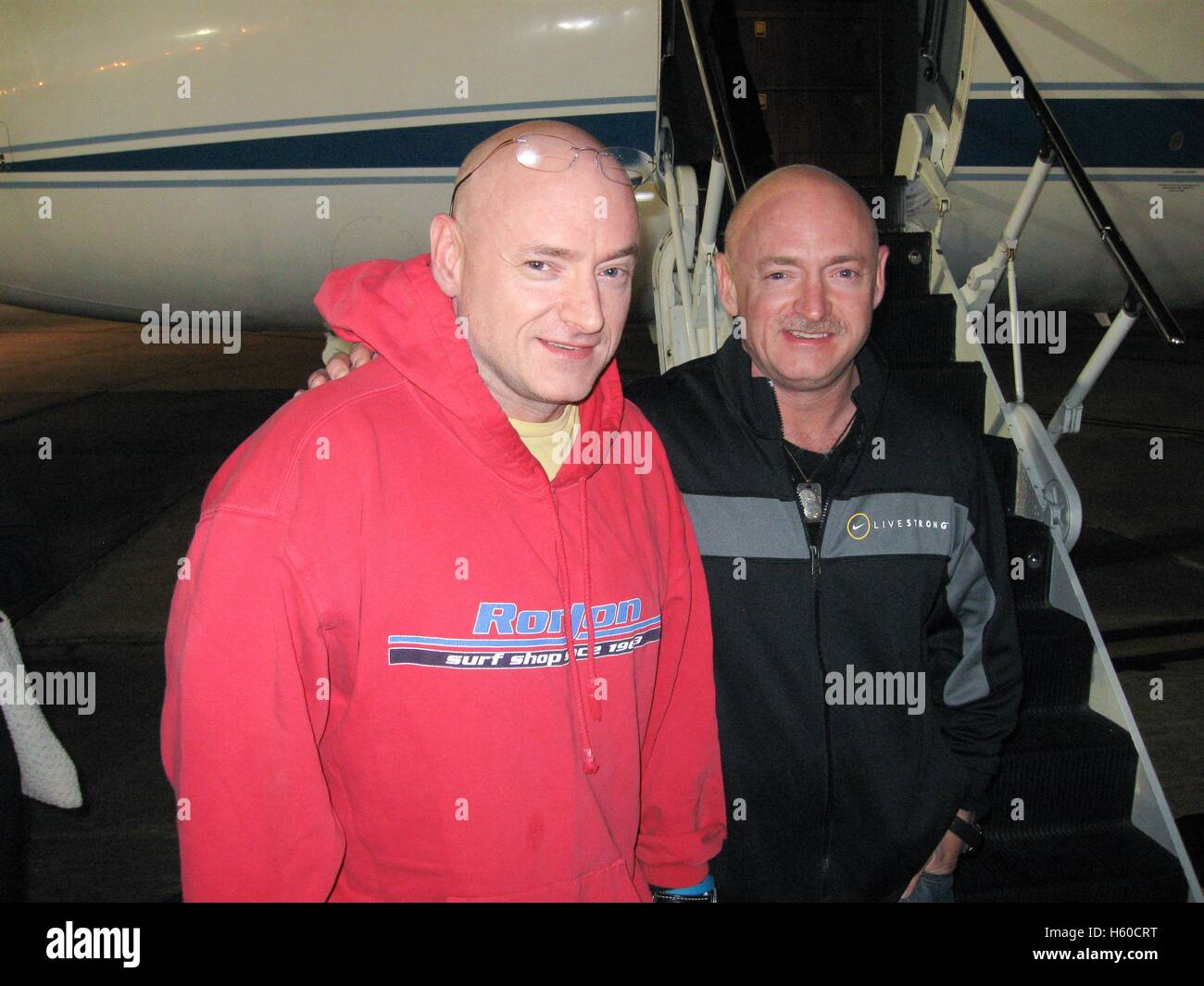 NASA International Space Station Expedition 26 astronaut Scott Kelly (left) is reunited with twin brother, astronaut Mark Kelly, after landing the Soyuz TMA-01M spacecraft in Kazakhstan at the Ellington Field Joint Reserve Base March 17, 2010 in Houston, Texas. Stock Photo