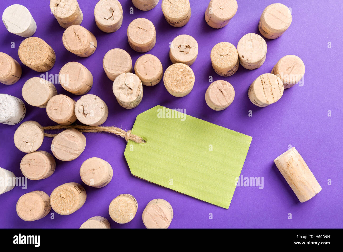 Wine cork stoppers with green label on purple background Stock Photo