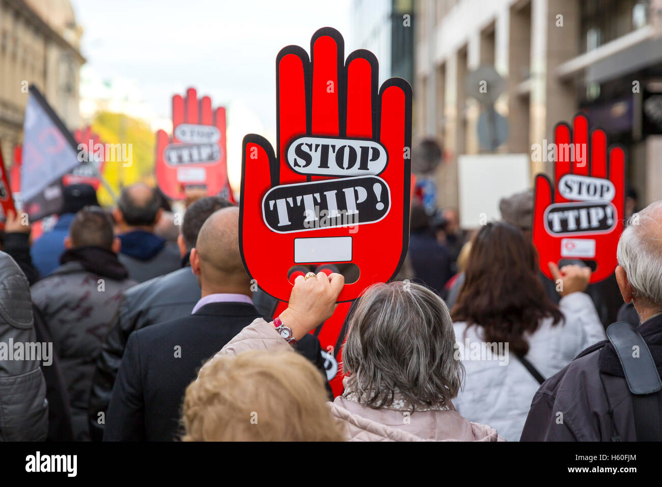 Activists are holding red hand signs 'Stop TTIP' during a demonstration against Free Trade Agreements TTIP, CETA and TISA betwee Stock Photo