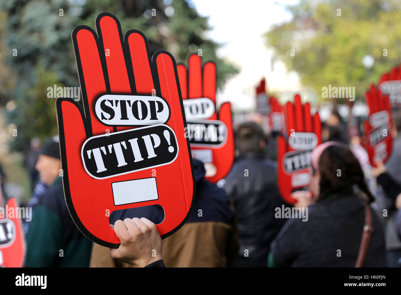 Activists are holding red hand signs 'Stop TTIP' during a demonstration against Free Trade Agreements TTIP, CETA and TISA betwee Stock Photo