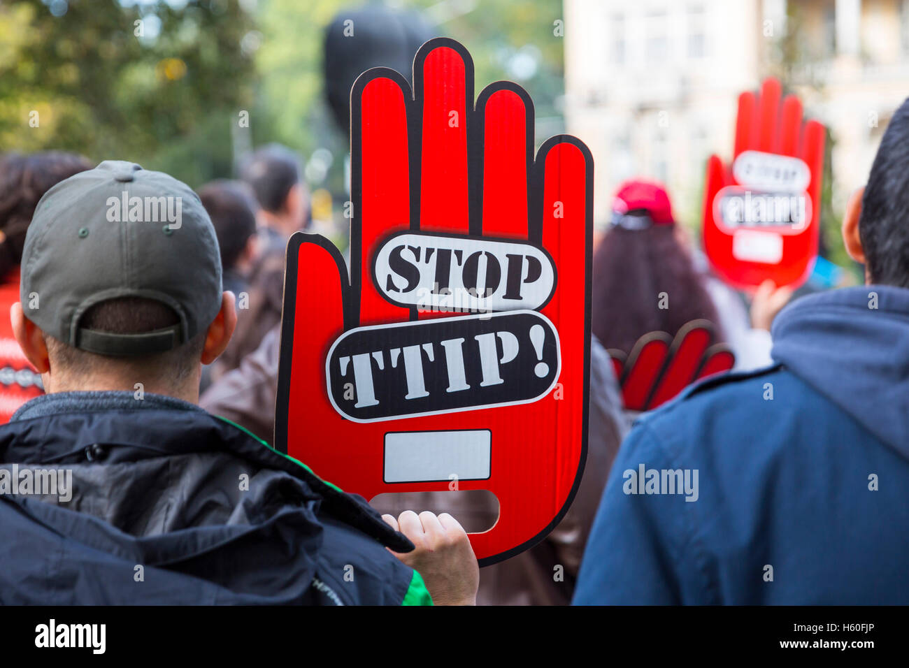 Activists are holding red hand signs 'Stop TTIP' during a demonstration against Free Trade Agreements TTIP, CETA and TISA betwee Stock Photo