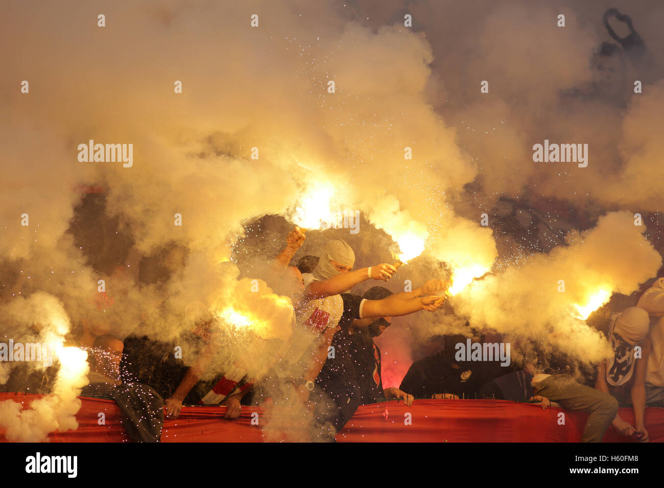 Sofia, Bulgaria - October 15, 2016: CSKA's football fans are holding torches in fire during a match between Bulgaria's CSKA and  Stock Photo