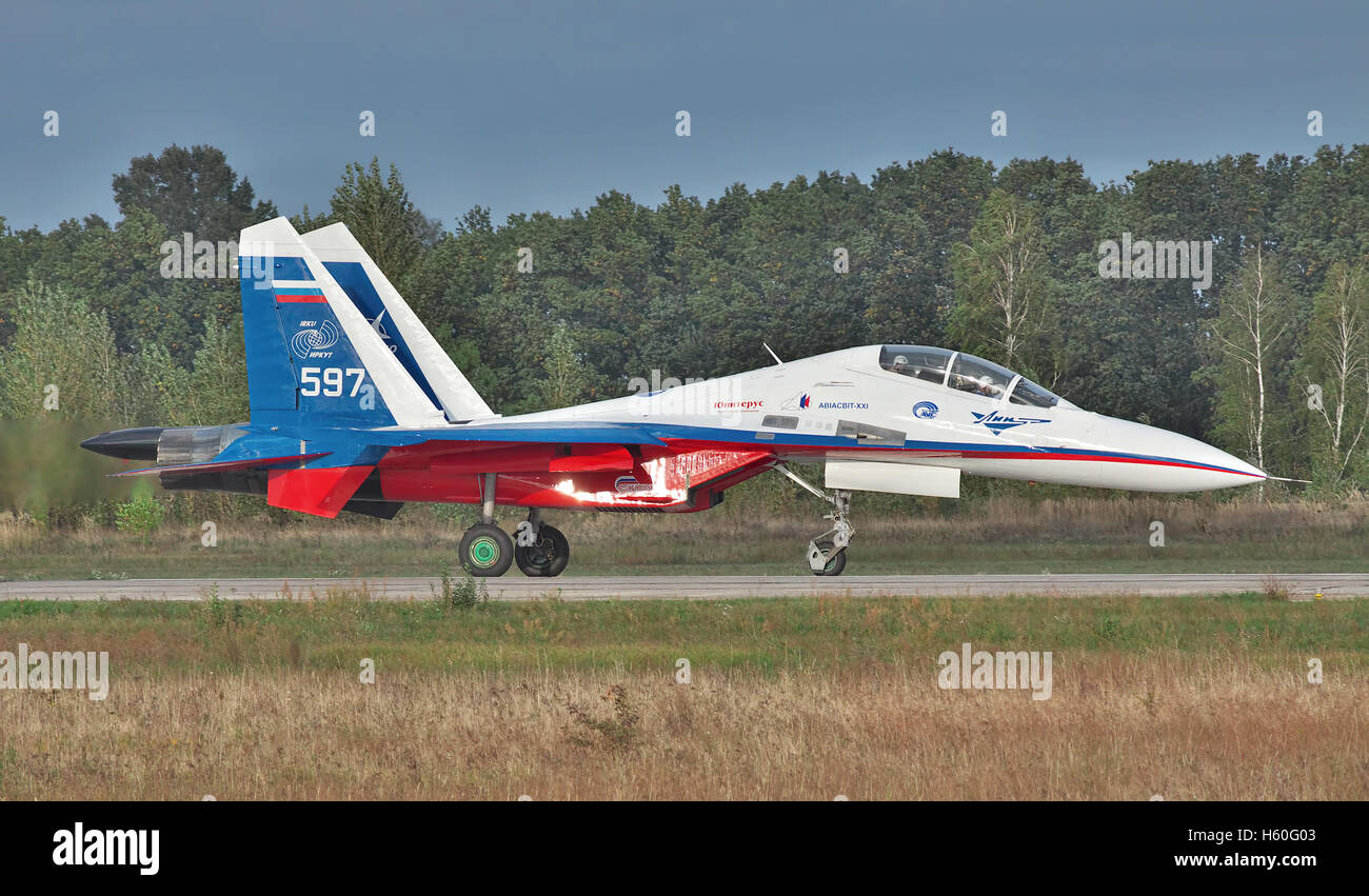 Kiev Region, Ukraine - September 28, 2010: Sukhoi Su-30LL fighter plane in Russian flag colors is taxiing along the runway after Stock Photo