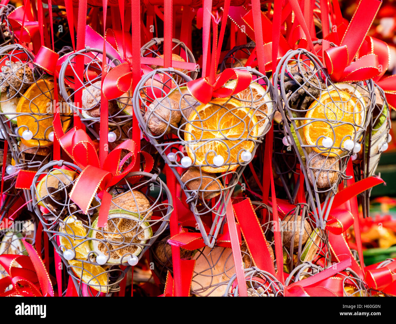 Many gifts hanged in a market stall of a Christmas little market in Austria, decorated with dried fruits. Stock Photo