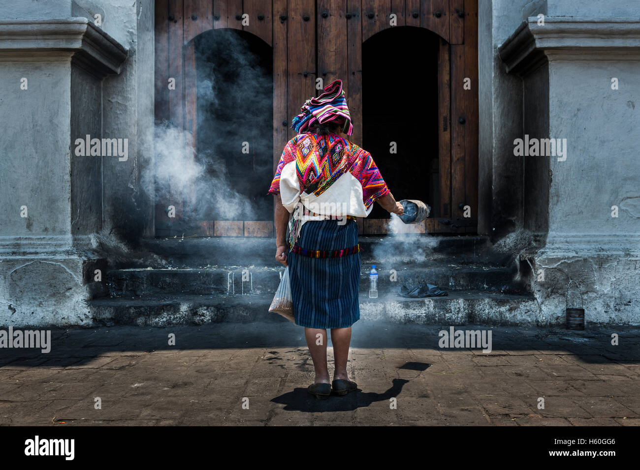 Chichicastenango, Guatemala - April 26, 2014: Mayan woman performing a ritual in front a church. Stock Photo