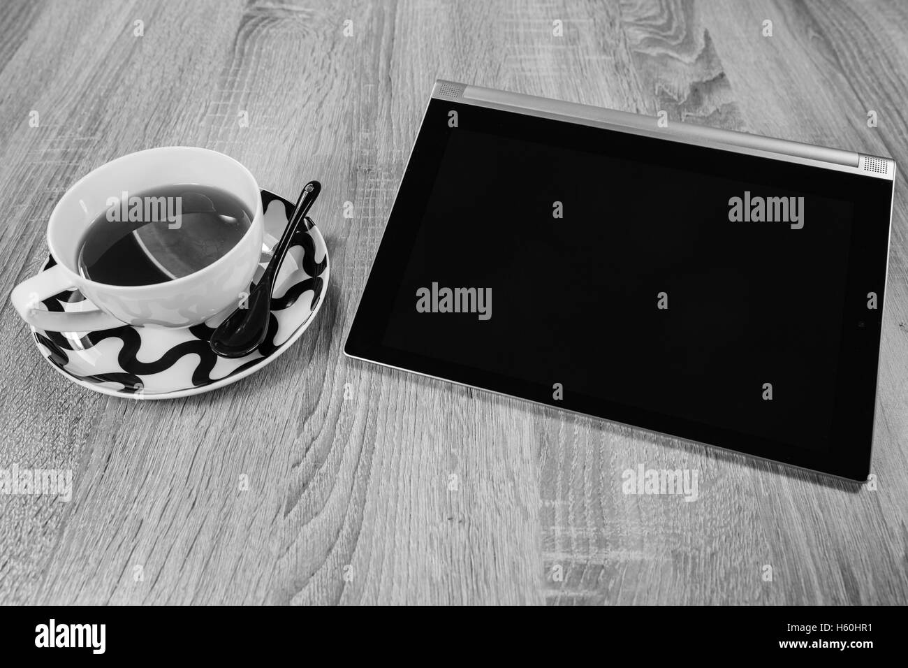 Tablet and a cup of tea. Black and white Stock Photo