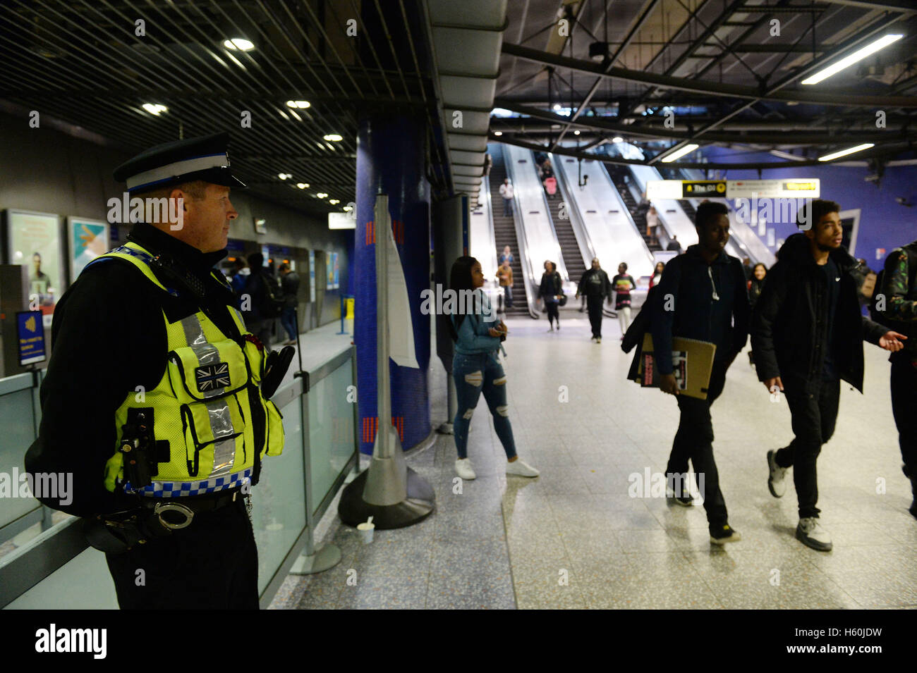 A police officer stands in the entrance hall to North Greenwich underground station. Stock Photo