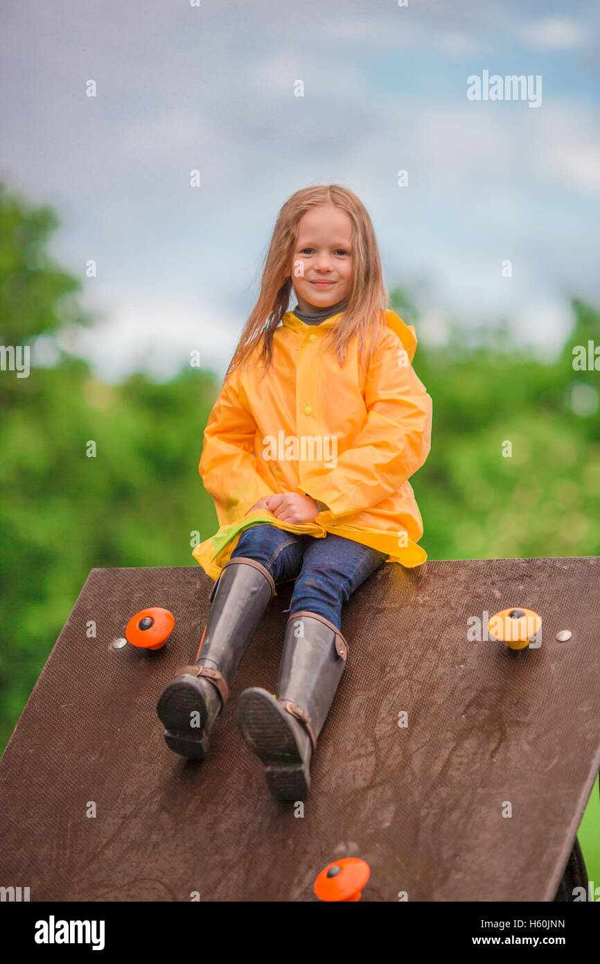 Happy little girl playng on outdoor playground Stock Photo - Alamy