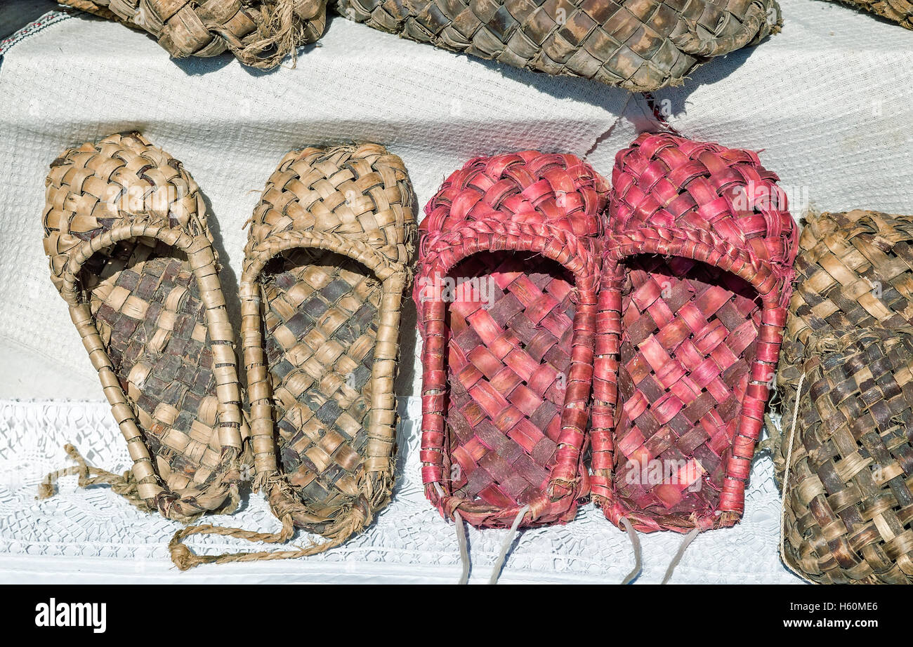 Demonstration of ancient objects of rural life: woven from tree bark sandals.  Shoes of the peasants in ancient Russia Stock Photo - Alamy