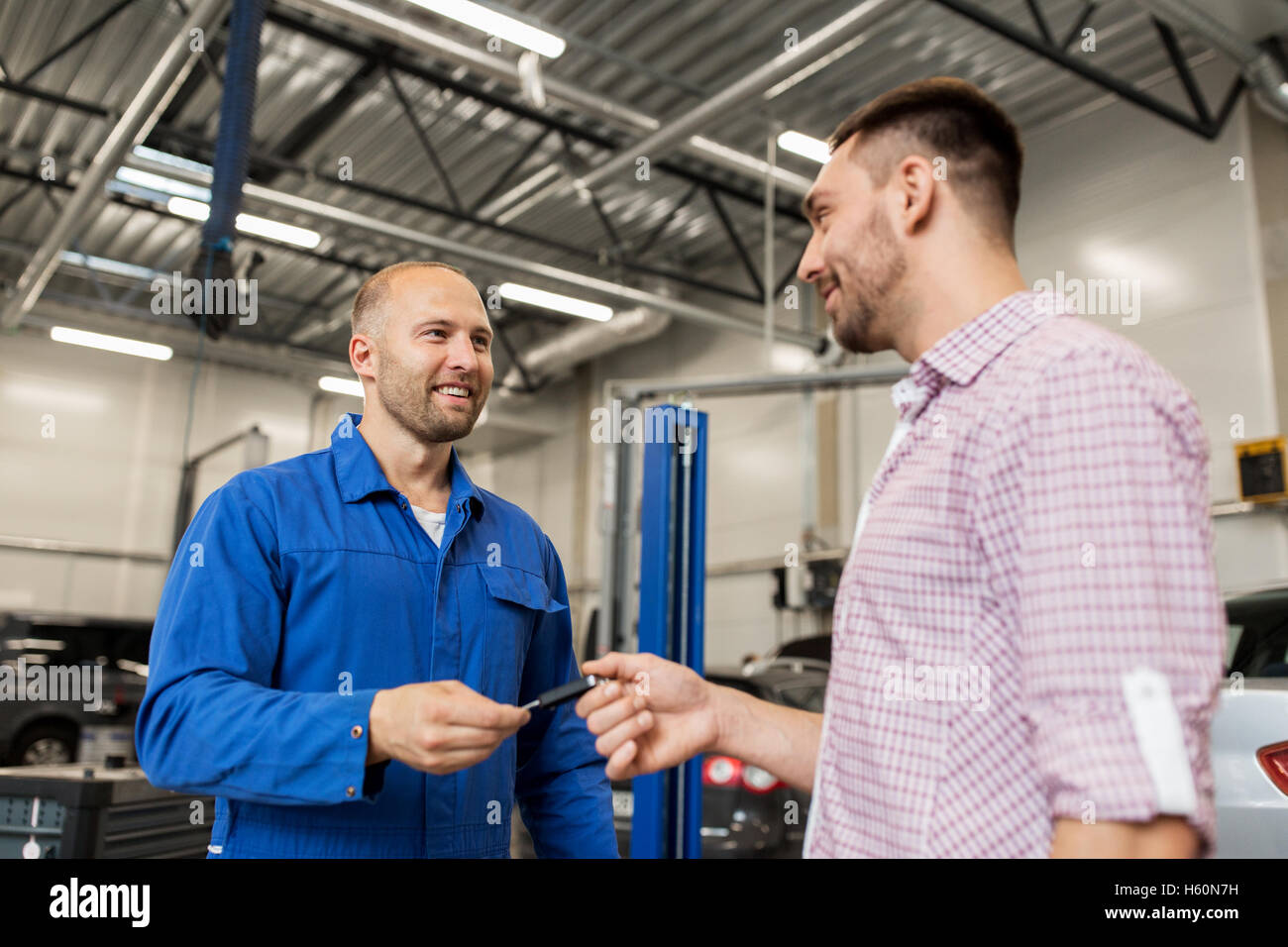 Mechanic man giving key customer hi-res stock photography and images ...